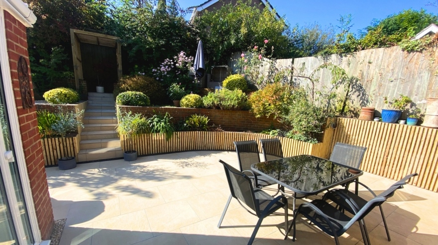 Sunny backgarden with a table and chairs